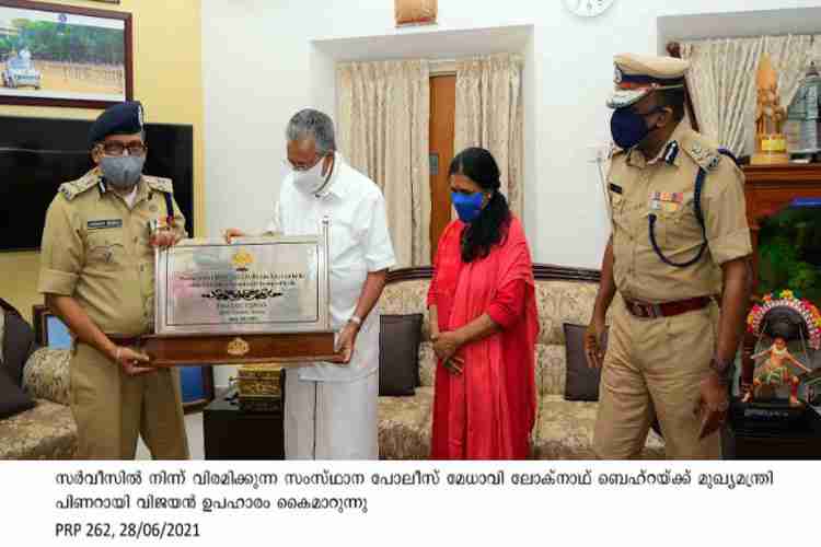Chief minister Pinarayi Vijayan presents memento to retiring Chief of Police Loknath Behra